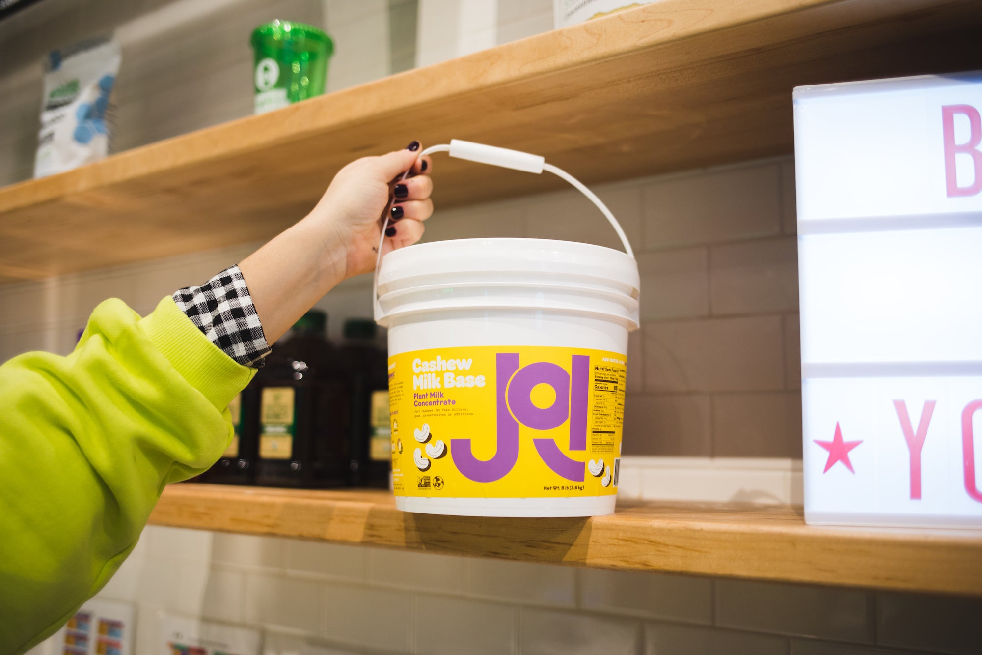 Im age of a JOI 8lb cashew pail in foodservice, a smoothie shop