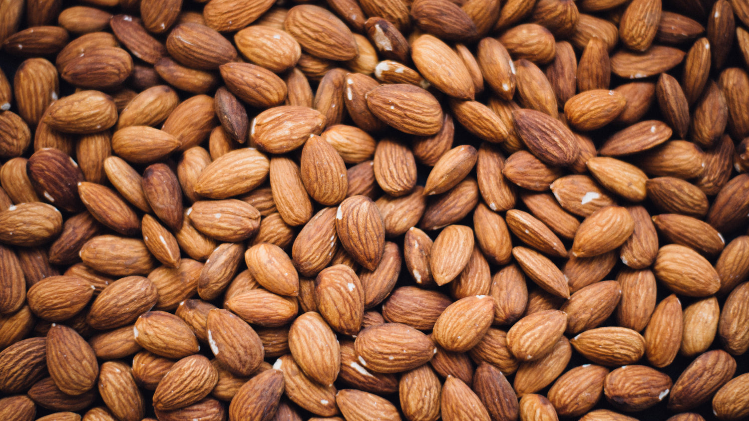 Image of a cluster of almonds with the skin on.